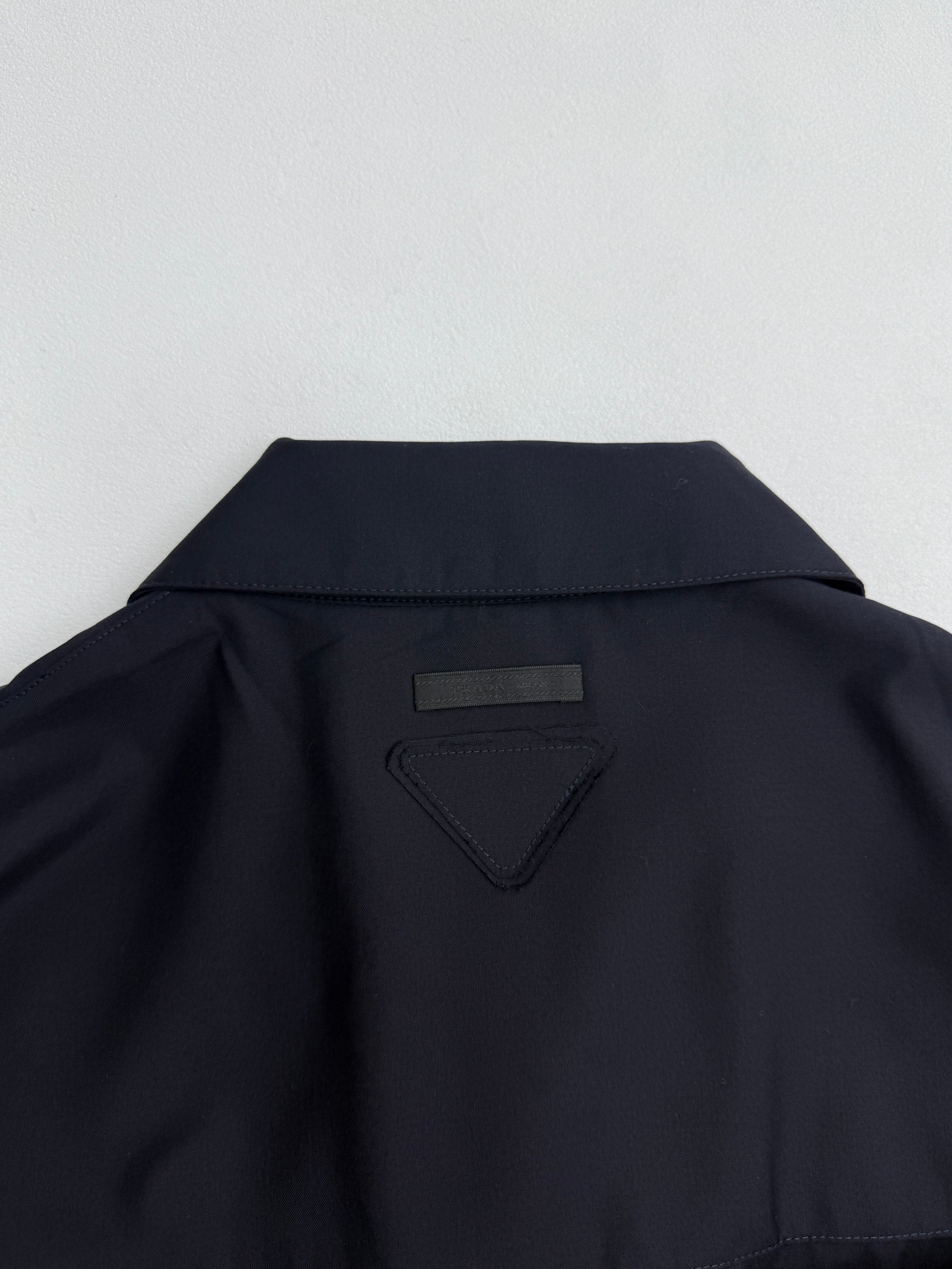 Prada long jacket dark navy back yoke with small triangular logo patch