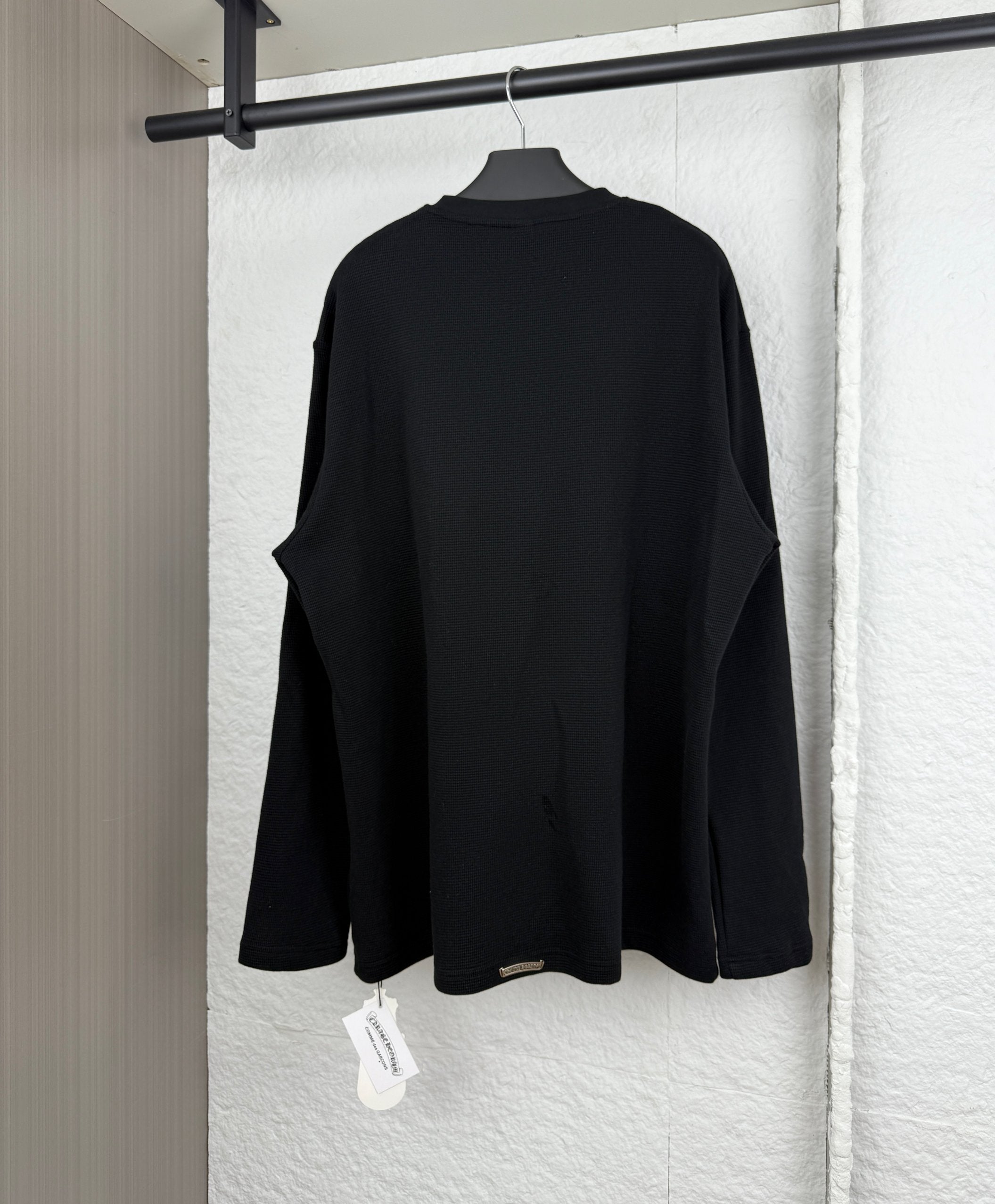 Black long-sleeve shirt, plain back view with relaxed fit and draped hem