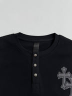 Black long-sleeve henley neckline with three button placket and textured panel detail
