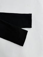 Black long-sleeve shirt sleeve with ribbed cuff and stitched hem
