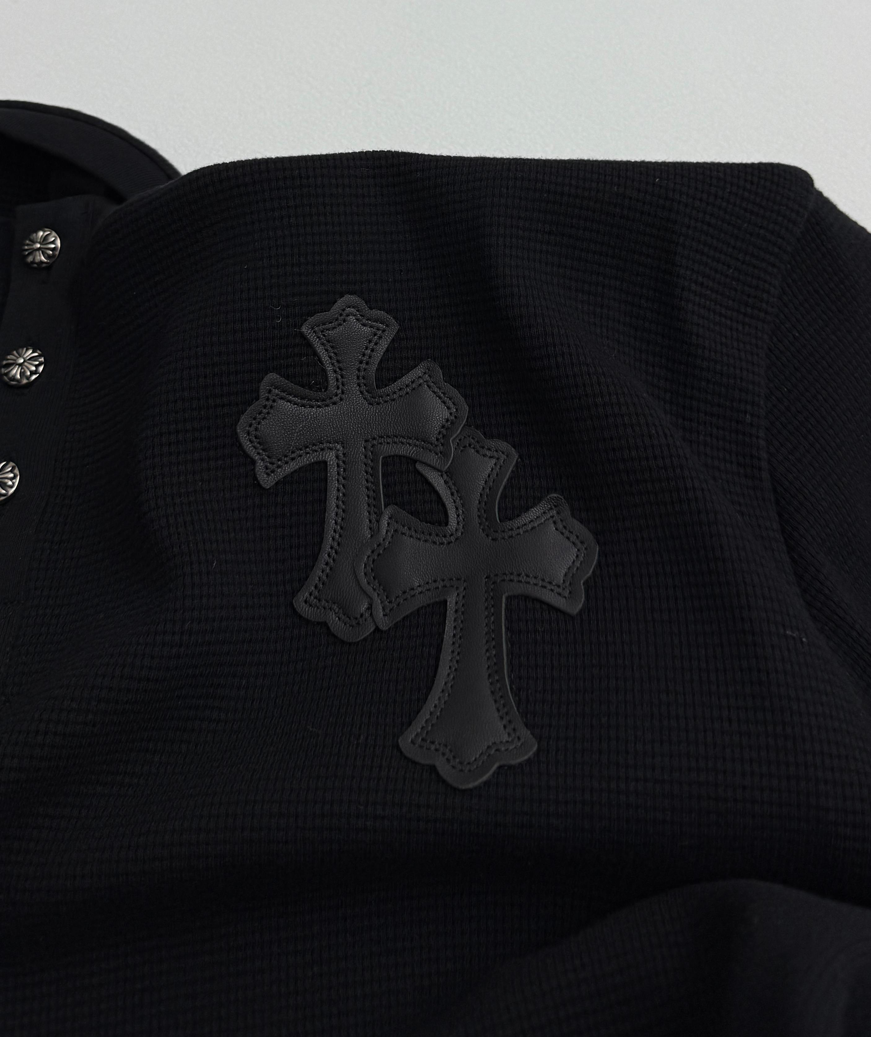 Black long-sleeve shirt with large cross appliqué on the chest
