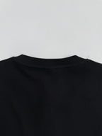 Black long-sleeve shirt back with crew neckline and textured fabric surface