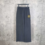 Balenciaga pants in dark navy with elastic waistband, wide straight legs, small side logo patch
