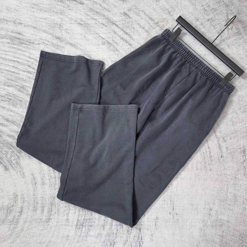 Balenciaga pants set of two in dark navy with elastic waistband and logo patch, angled view