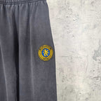 Balenciaga pants with side logo patch on dark navy fabric, full leg section
