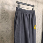 Balenciaga pants in dark navy with elastic waistband, side profile, small logo patch