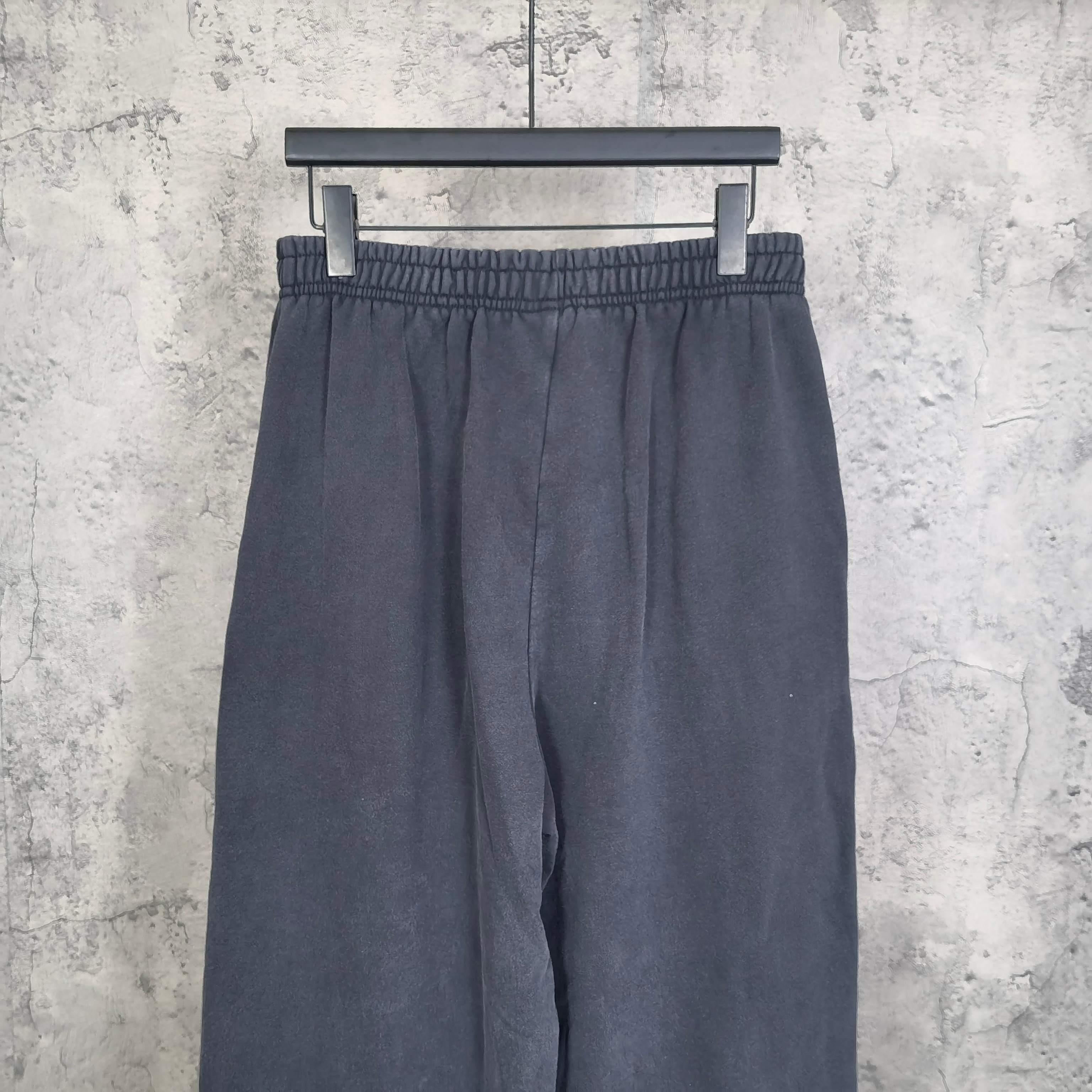 Balenciaga pants in dark navy with elastic waistband and relaxed wide legs, front view