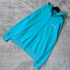 Turquoise zip-up hoodie with hood and front pocket, shown from side angle