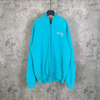 Turquoise zip-up hoodie with hood, front pocket, and Balenciaga logo on chest