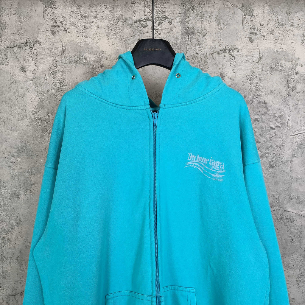 Turquoise zip-up hoodie with hood, full zipper, and Balenciaga logo on chest