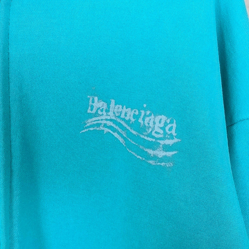 Turquoise hoodie fabric with Balenciaga logo print near center