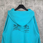 Turquoise zip-up hoodie hood with Balenciaga logo centered on back