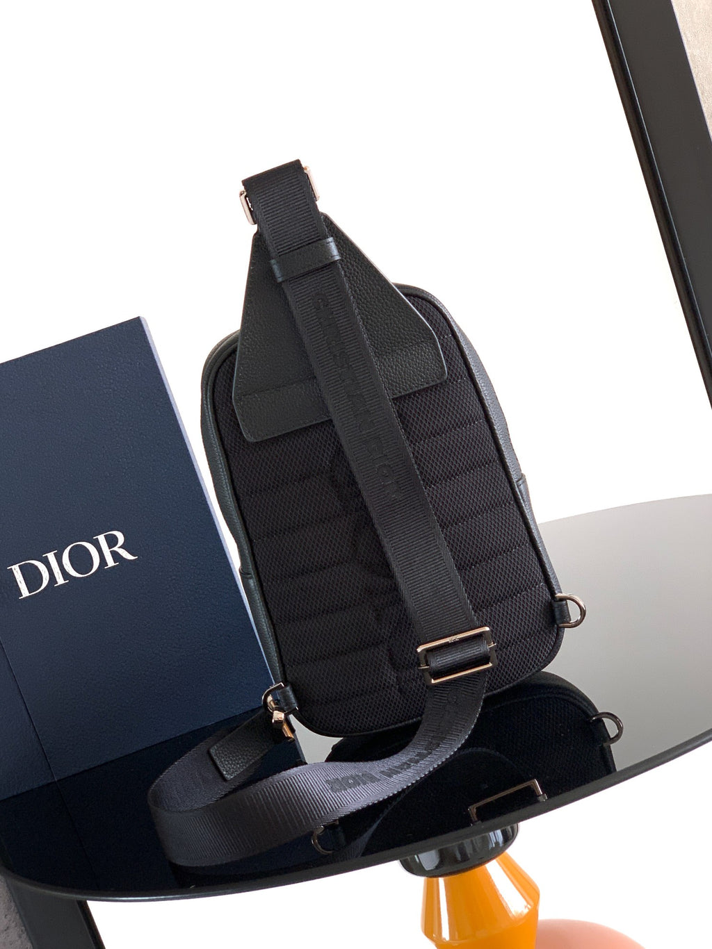 Dior mini backpack bag, black pebbled leather, adjustable shoulder straps and front buckle