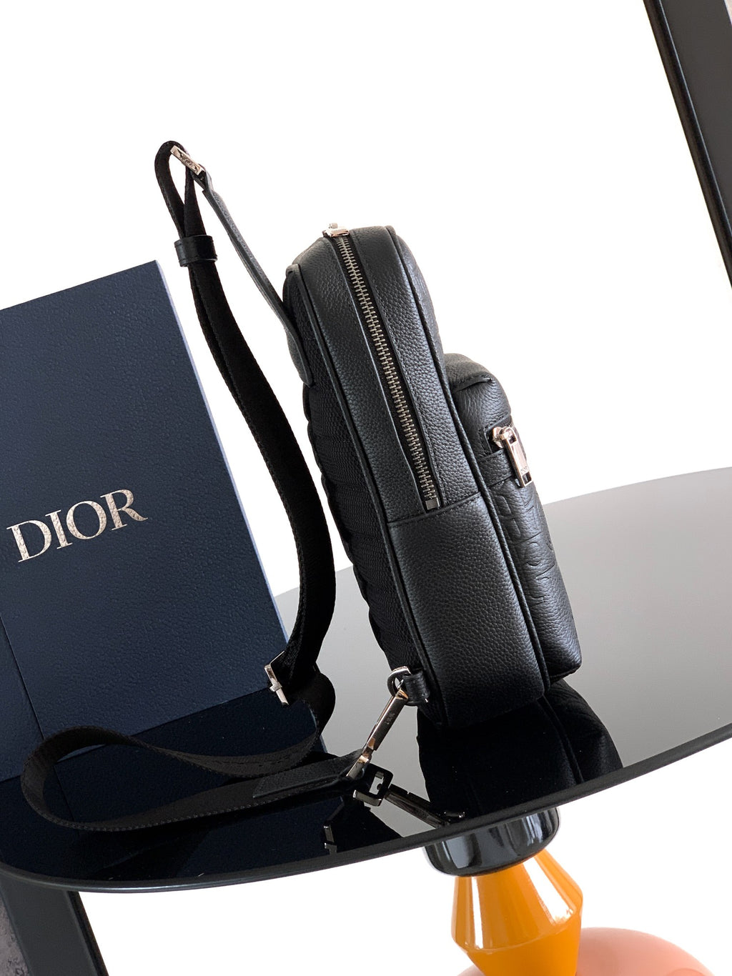 Dior men's mini backpack bag side view with adjustable strap and zip closure