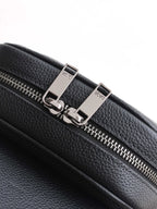 Dior mini bag zipper detail, black pebbled leather with metal pull and 'Dior' markings