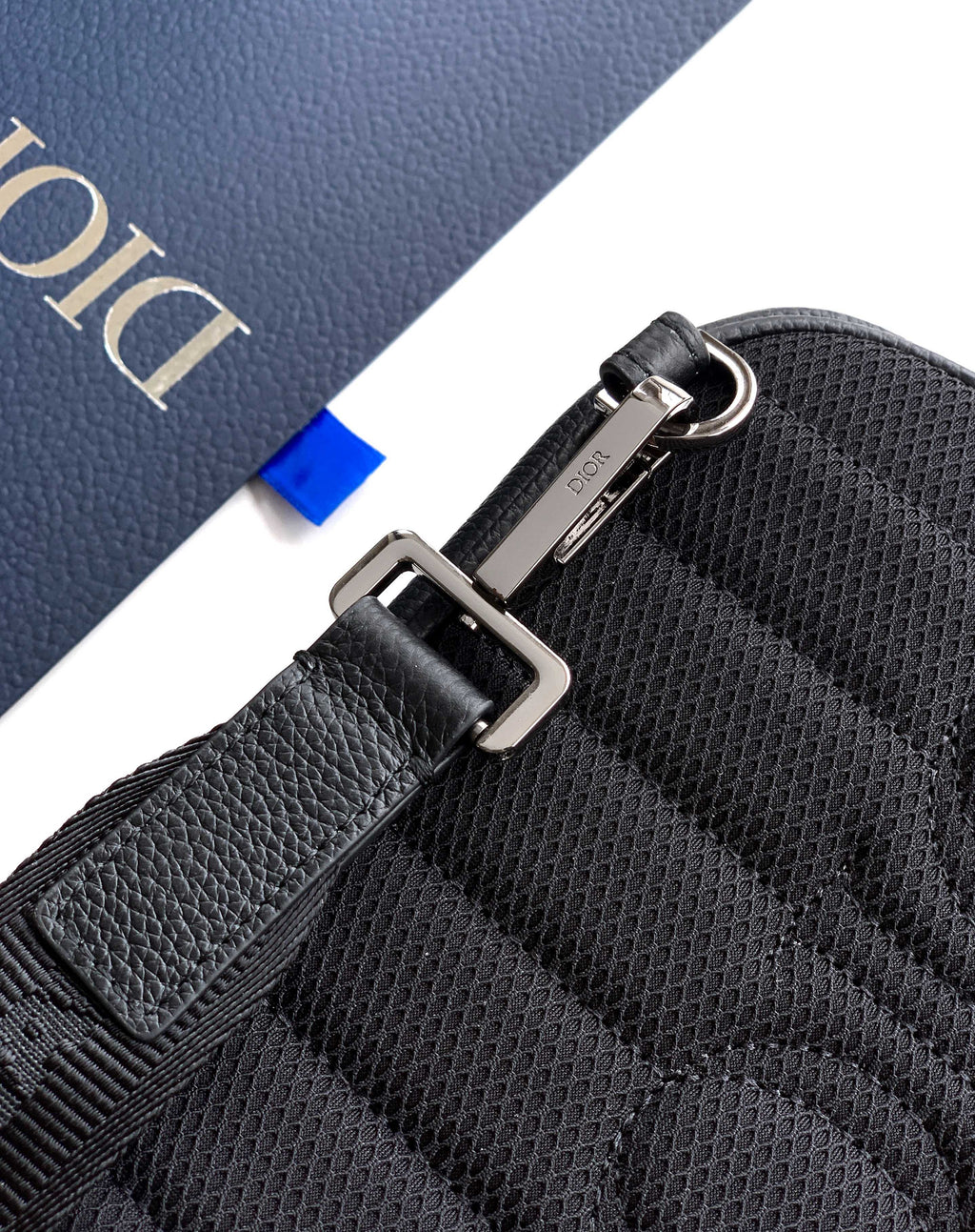 Dior men's mini bag corner with strap hardware and textured leather surface