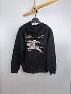 Black pullover hoodie with hood and large Burberry graphic print on the front.