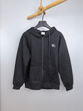 Black zip-up hoodie with hood, front kangaroo pocket, and small chest logo detail.