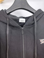 Black zip-up hoodie hood with drawstrings and close-up of the front zipper area.