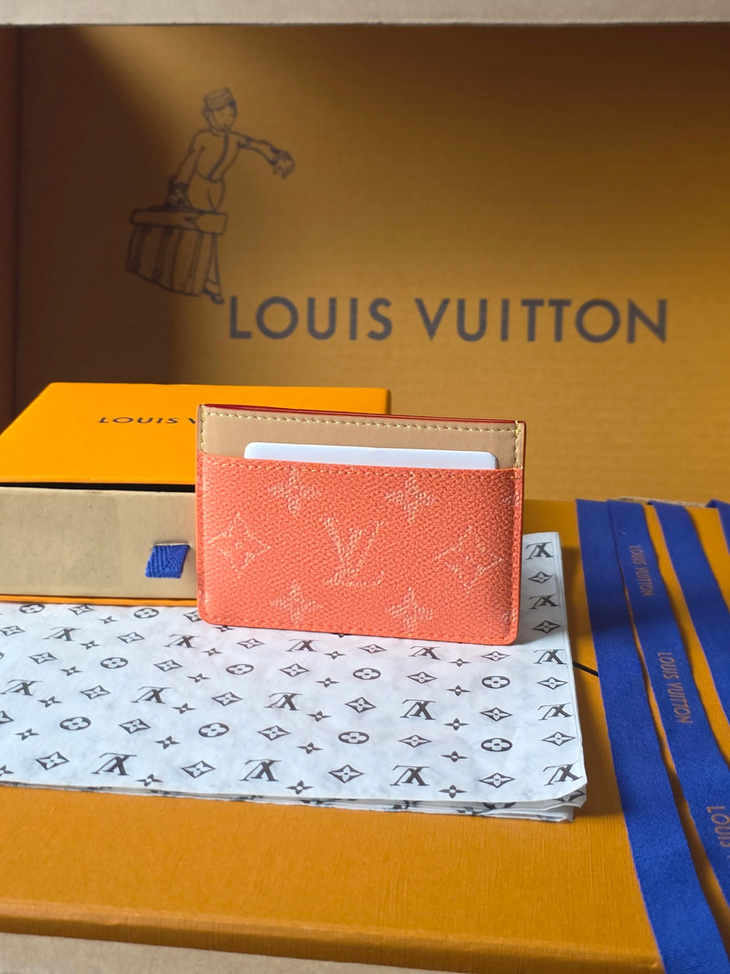 Coral Louis Vuitton card holder with monogram pattern and top window slot