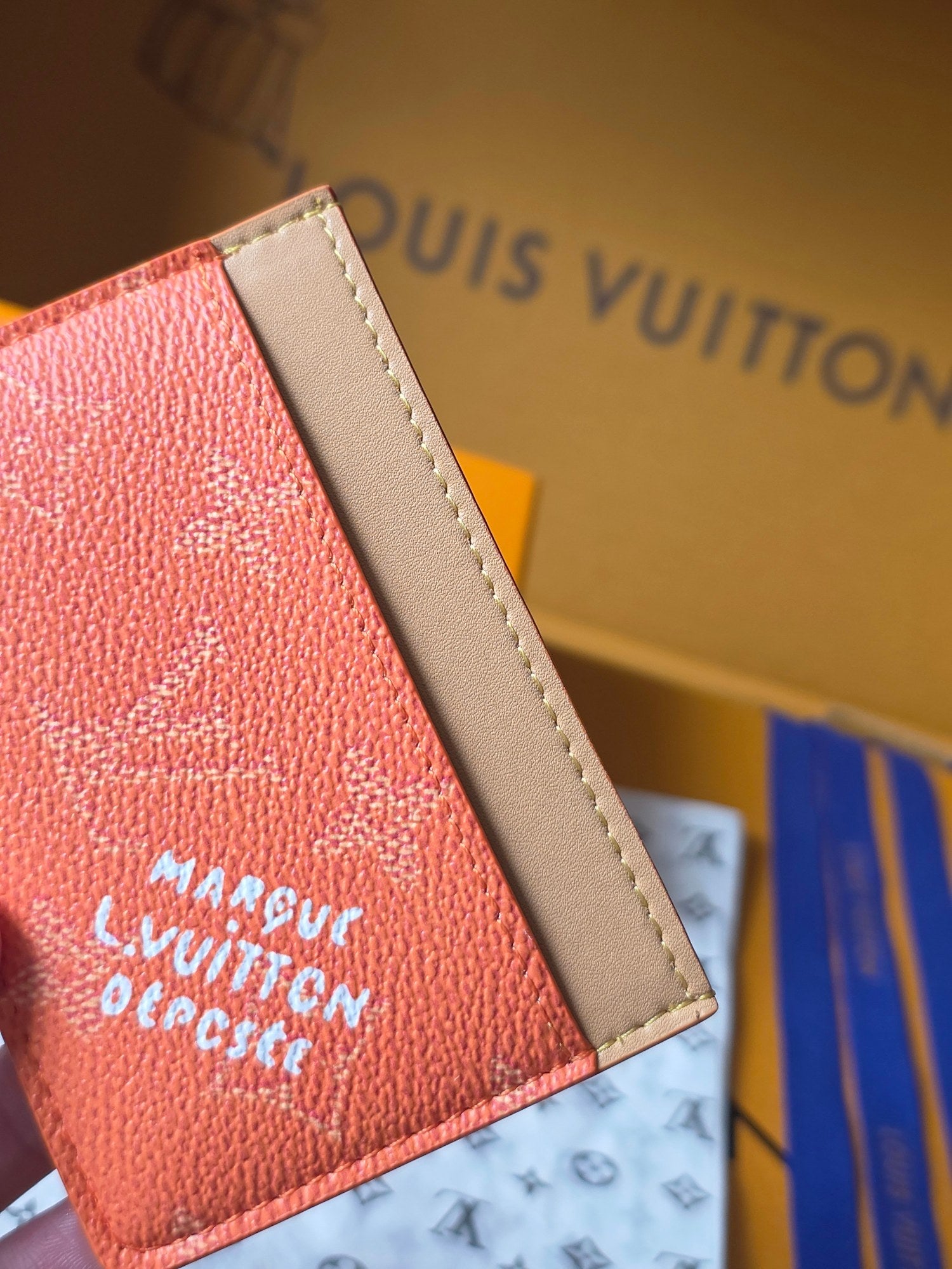 Coral Louis Vuitton card holder side with beige trim and white logo text