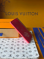 Louis Vuitton small pink monogram card holder angled with tan edging and top slot