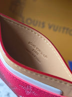 Louis Vuitton small pink monogram card holder interior view with beige lining and embossed text