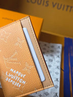 Small tan Louis Vuitton monogram bag close-up of white card slot and side stitching
