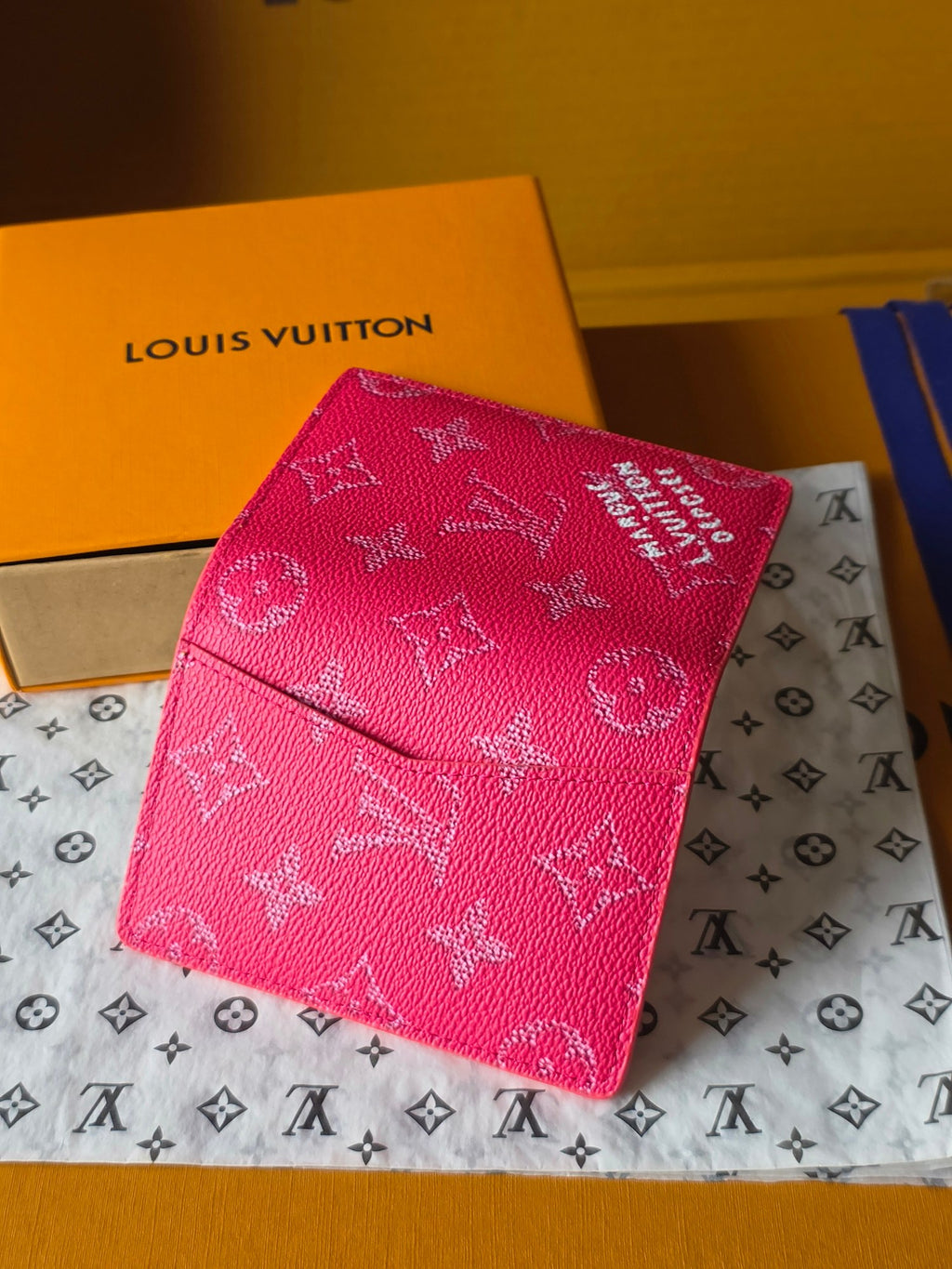 Pink monogram small wallet bag closed with embossed logo pattern