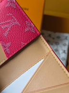 Beige interior and pink monogram exterior edge of card holder