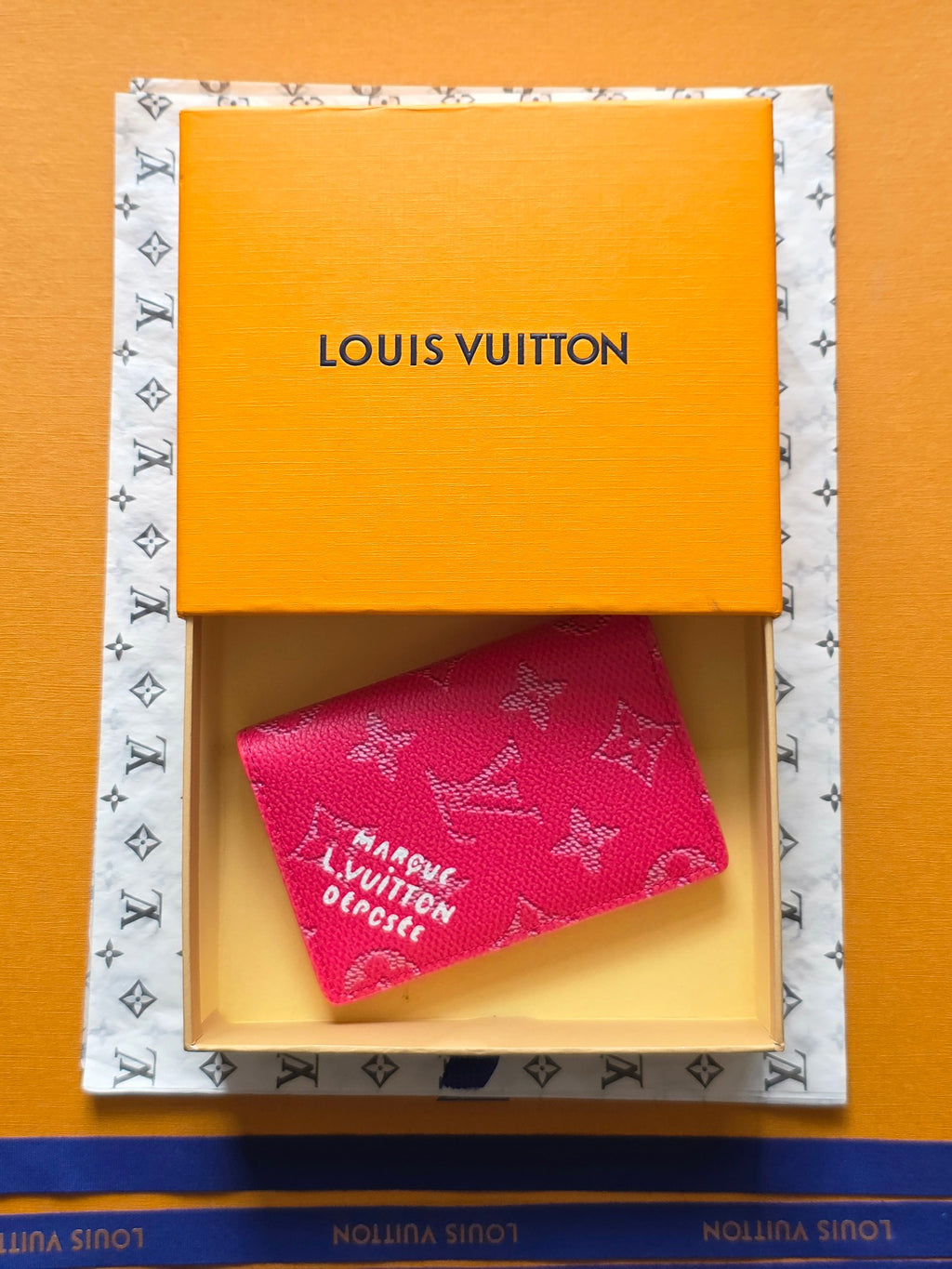 Small bag in pink monogram canvas, partially visible inside gift box, Louis Vuitton.