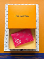 Small bag in pink monogram canvas, partially visible inside gift box, Louis Vuitton.