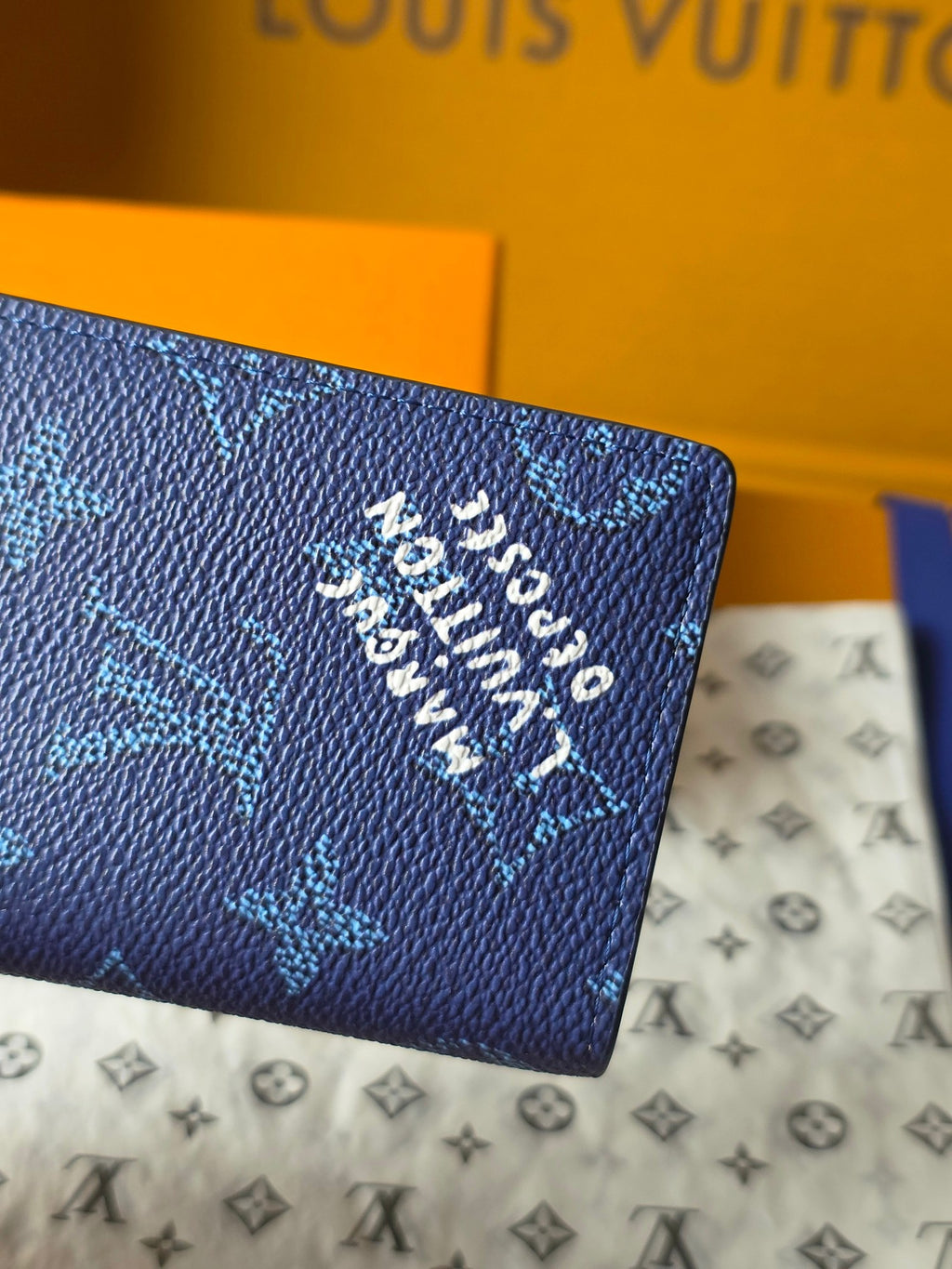Louis Vuitton blue monogram wallet with embossed logo text