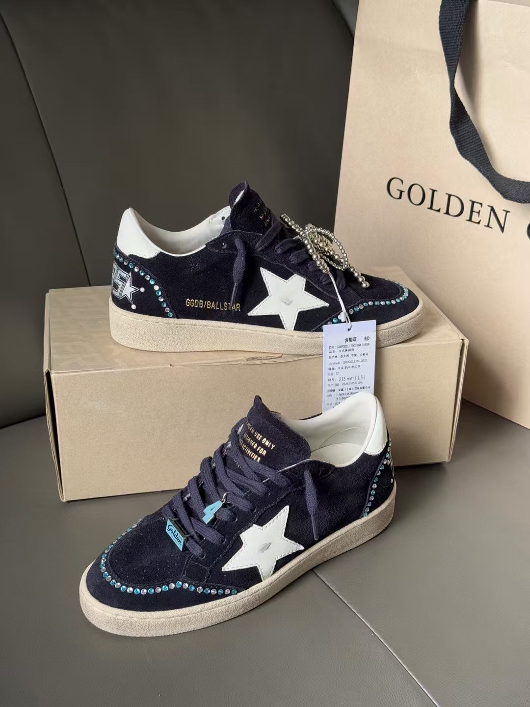 Golden Goose sneakers, dark navy canvas with white star patch, lace-up and chain trim