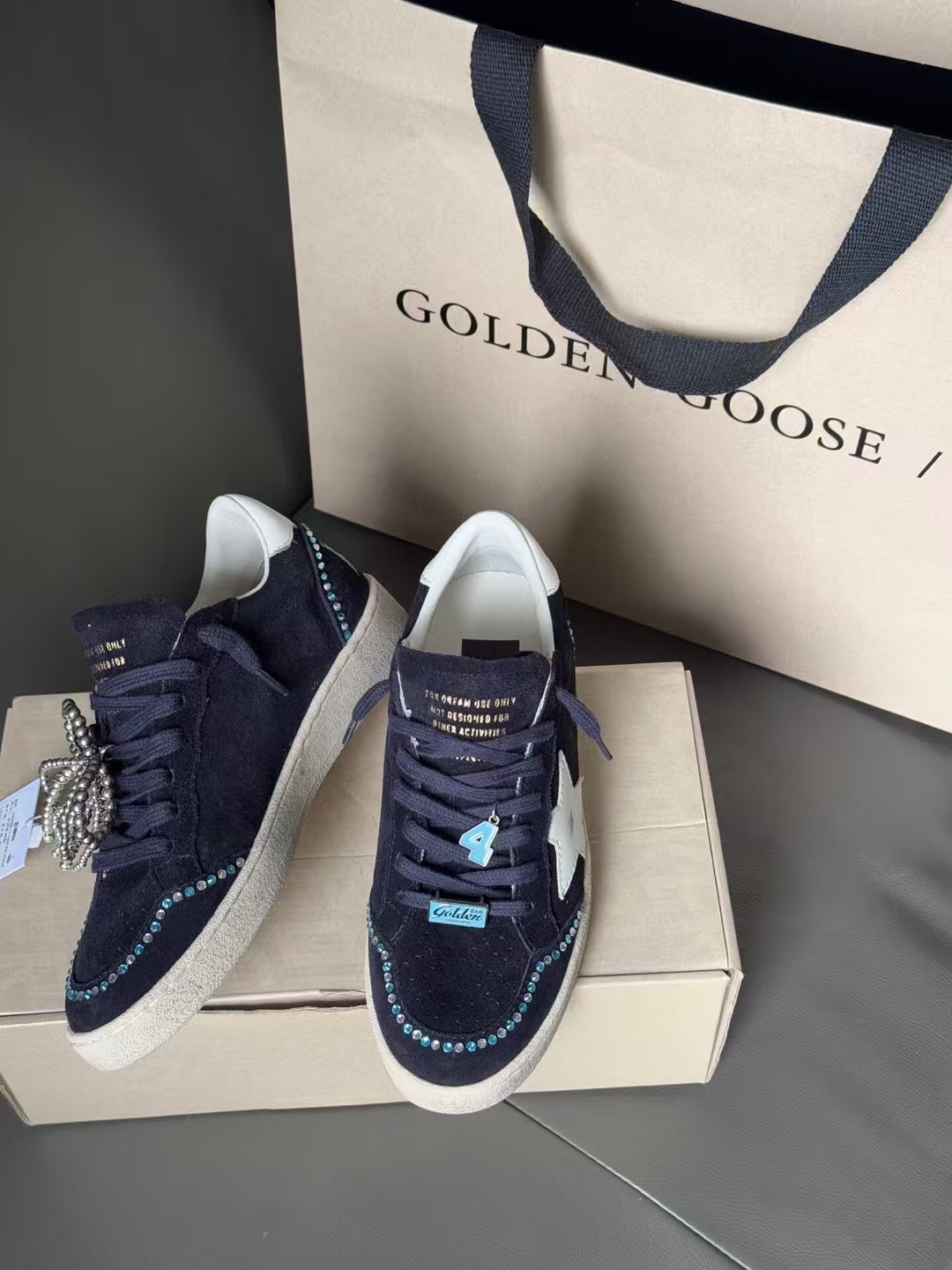 Golden Goose sneakers in dark navy, white star on side, lace-up with sparkling edge trim