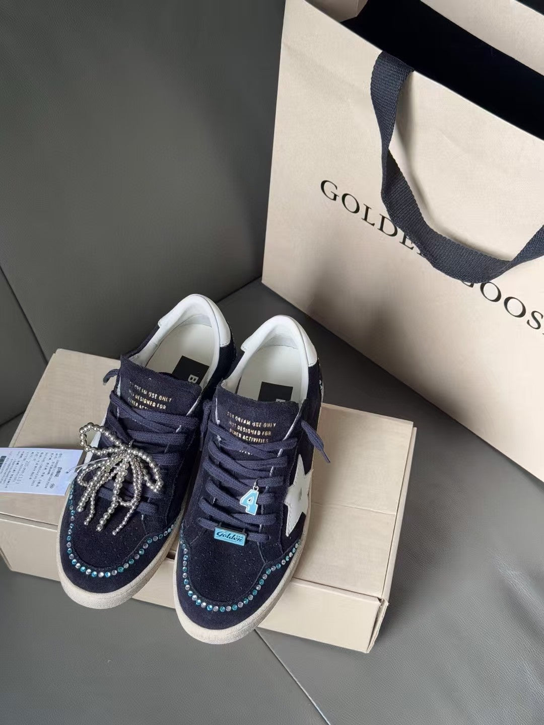 Golden Goose sneakers, dark navy with white star, lace-up and metallic chain bow decoration