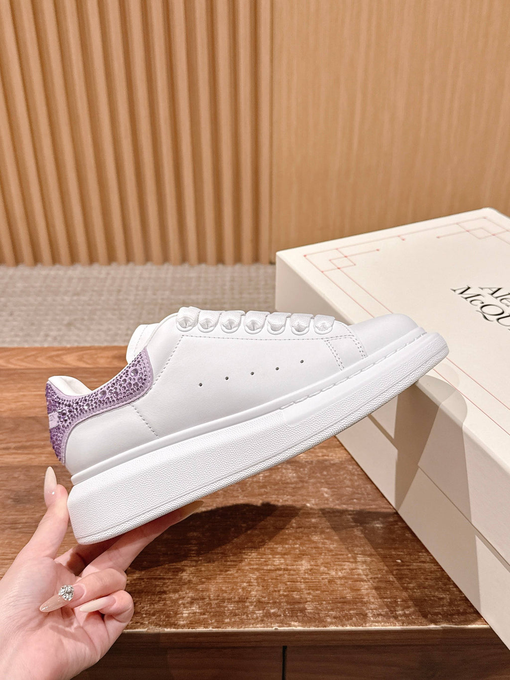 White low-top sneakers with purple glitter heel detail and lace-up front