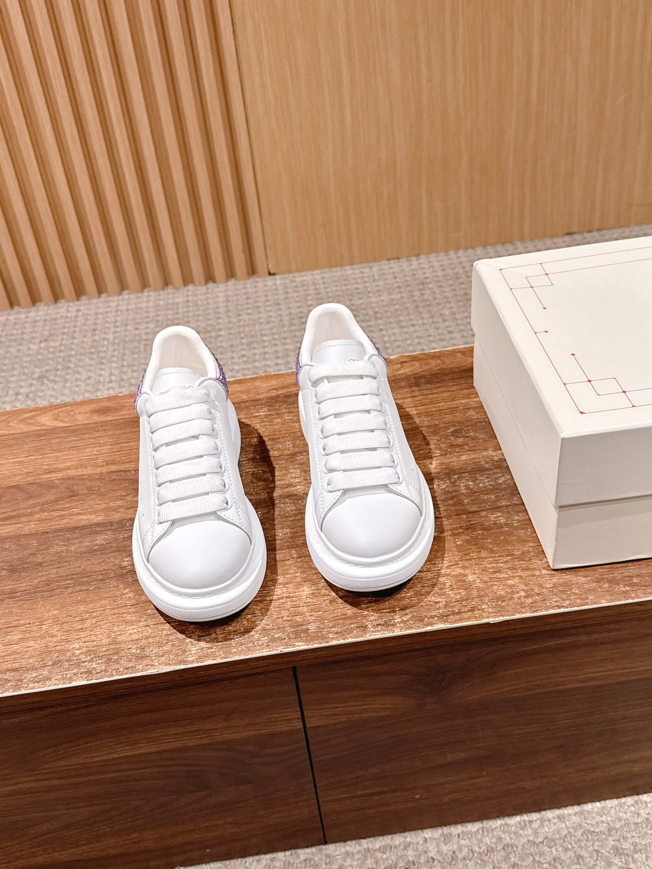 White lace-up sneakers with rounded toe and clean low-profile sole