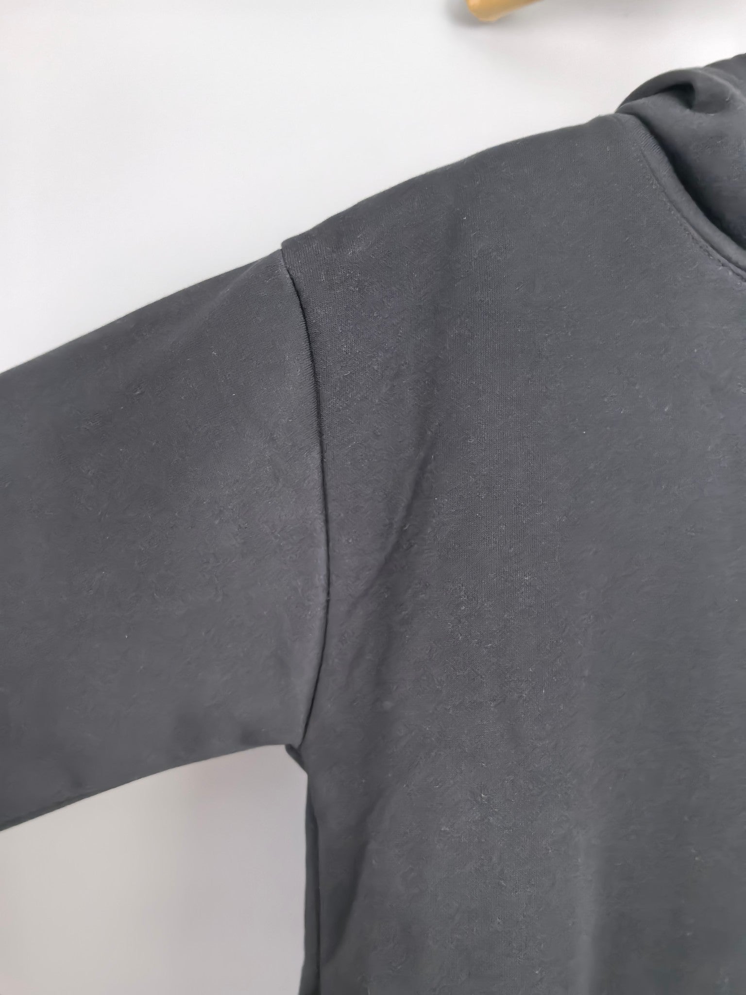 Black hoodie shoulder and sleeve seam detail