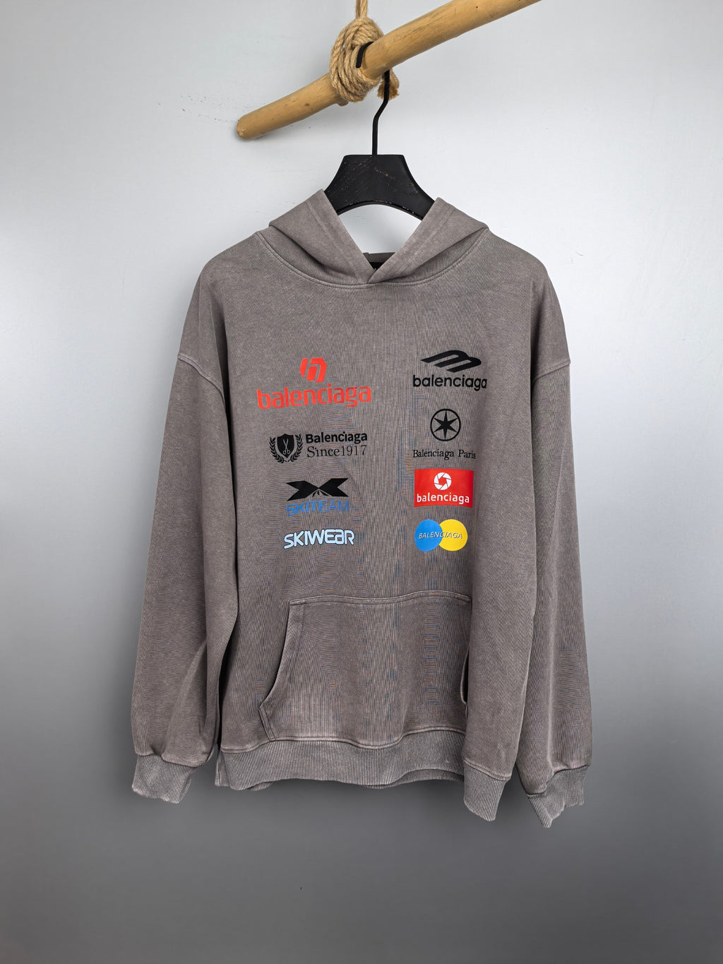Gray Balenciaga-style pullover hoodie with multicolor logo graphic and front pouch pocket