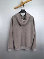 Gray pullover hoodie with hood and long sleeves on a hanger