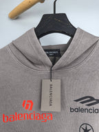 Gray pullover hoodie neckline with drawstring hood and hanging Balenciaga tag