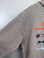 Gray pullover hoodie sleeve with partial logo print and crew neckline