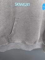 Gray hoodie front pouch pocket with SKWEAR logo above the hem