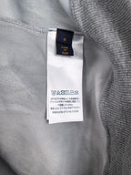 Interior neck label on gray sweatshirt with care information tag
