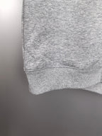Gray sweatshirt hem with ribbed cuff detail at the sleeve
