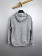Gray kids pullover hoodie on a hanger with hood and long sleeves