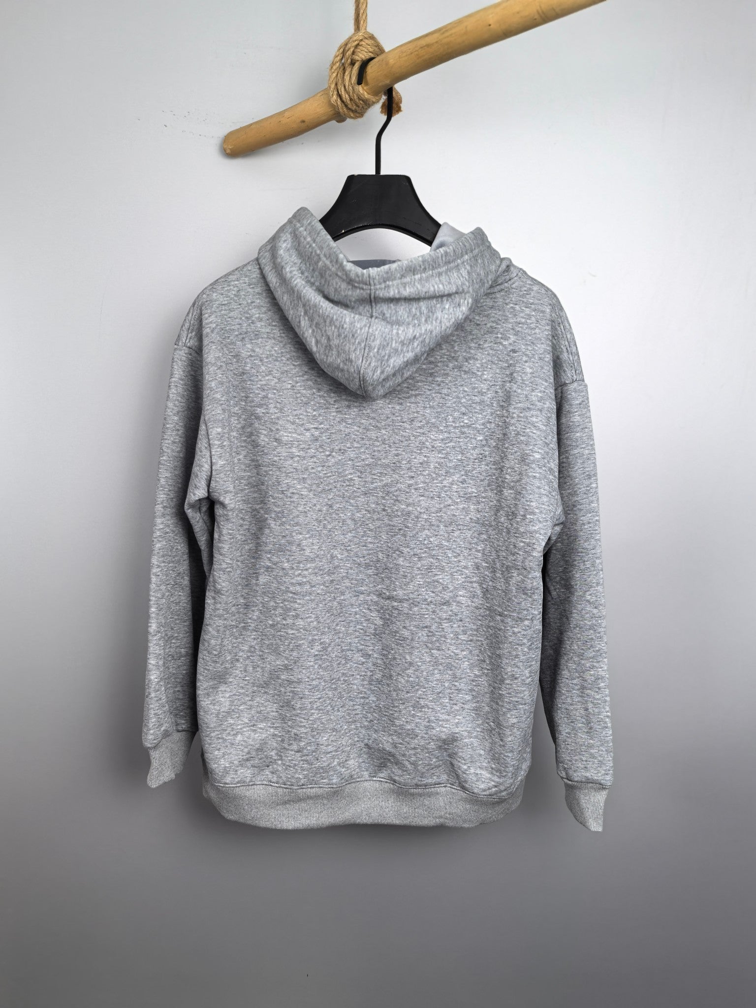 Gray kids pullover hoodie on a hanger with hood and long sleeves