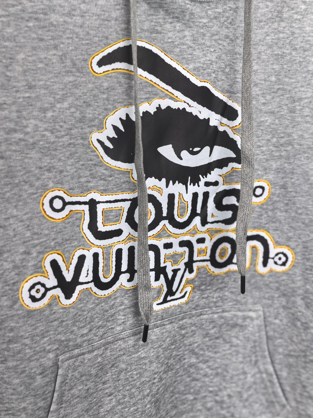 Gray kids hoodie close-up of front graphic print with bold Louis Vuitton emblem
