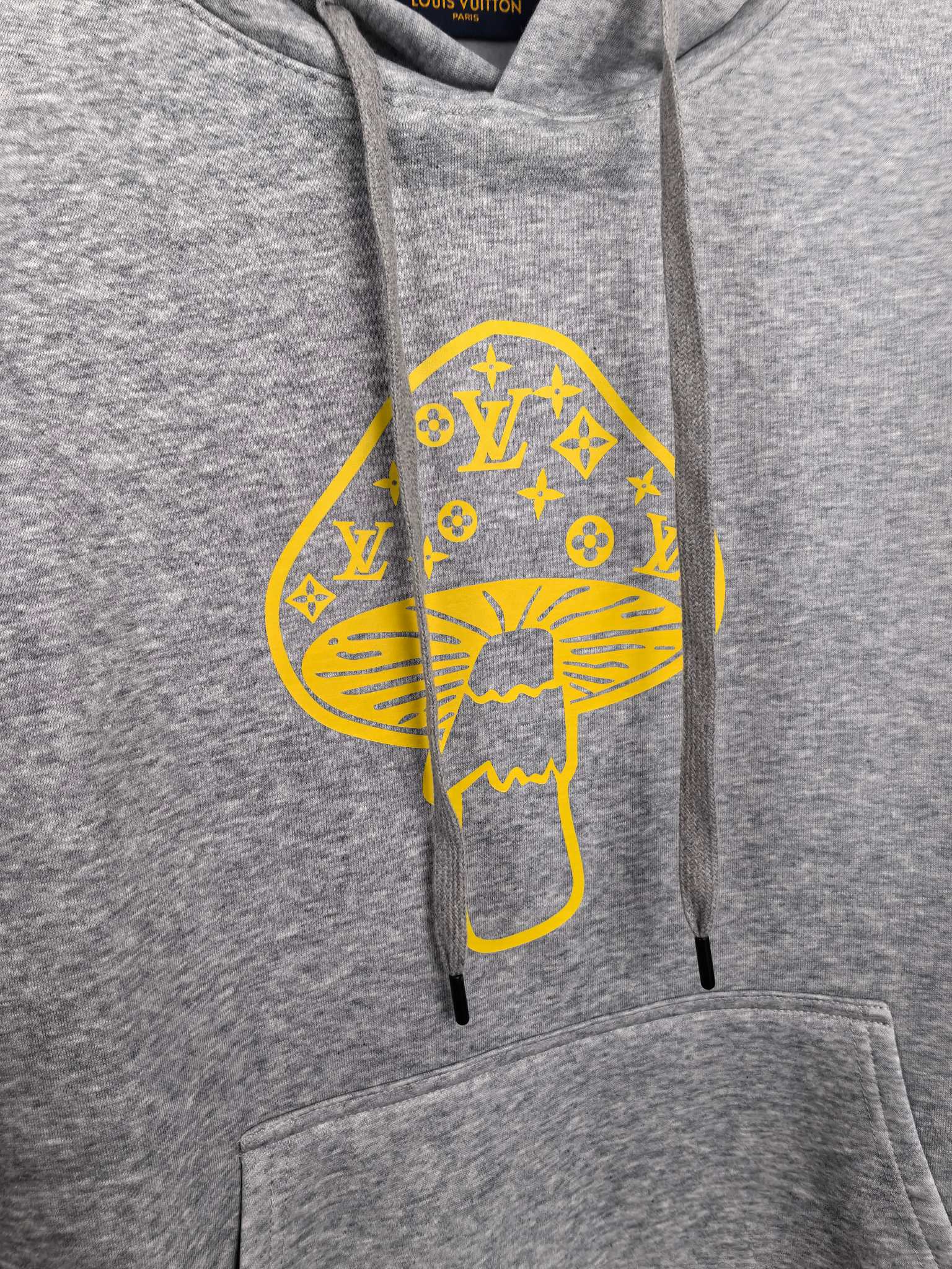 Gray hoodie with large yellow graphic print, drawstrings, and front pocket
